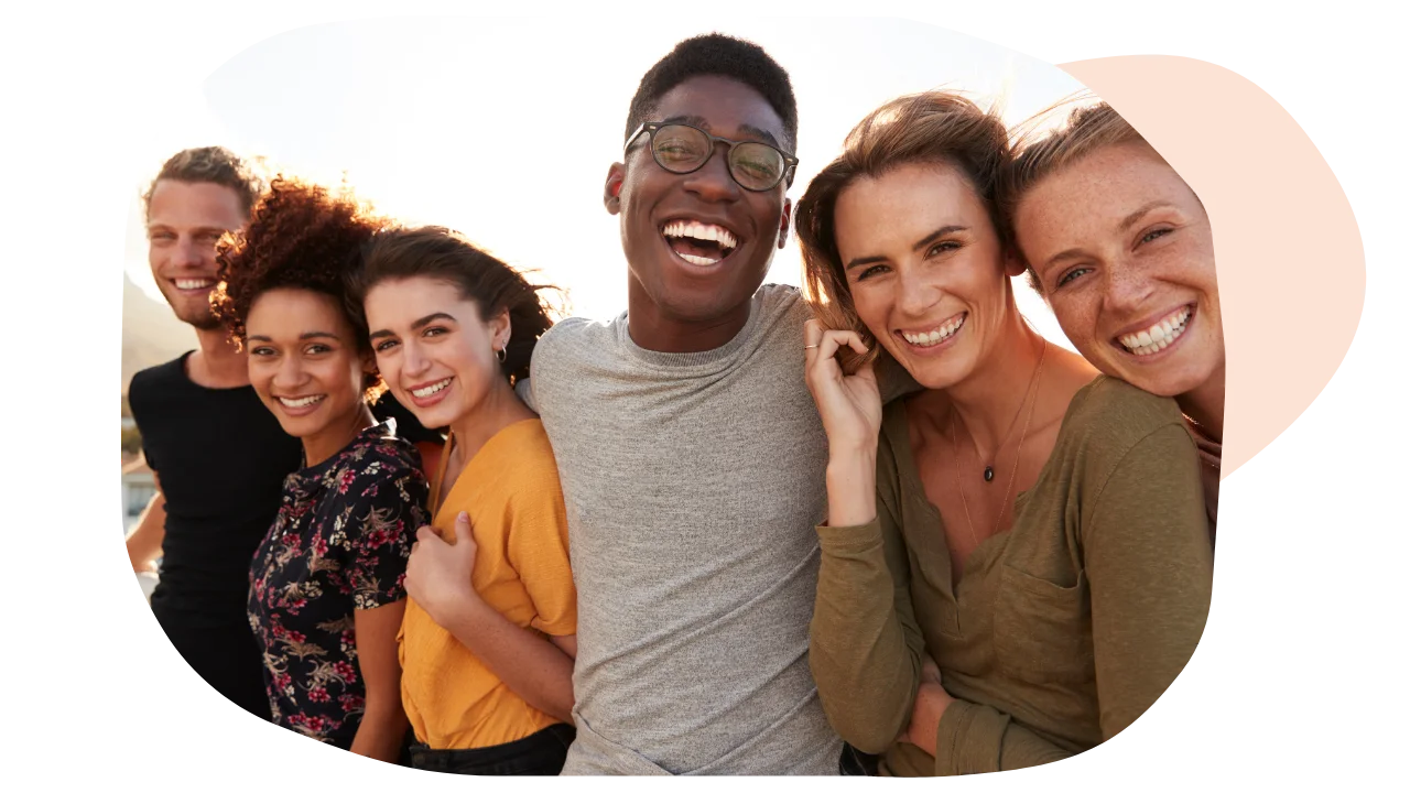 A group of people with mental health conditions smiling and having fun